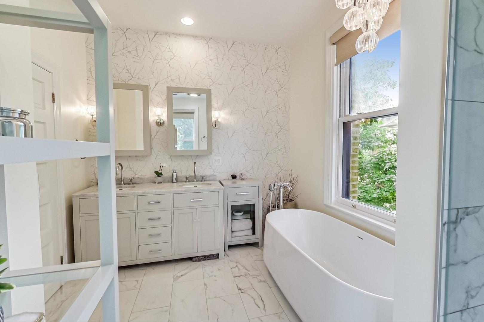 50 MacArthur Loop Highland Park, IL 60035 - Photo 19 of 44 a spacious bathroom with a granite countertop tub sink and a mirror