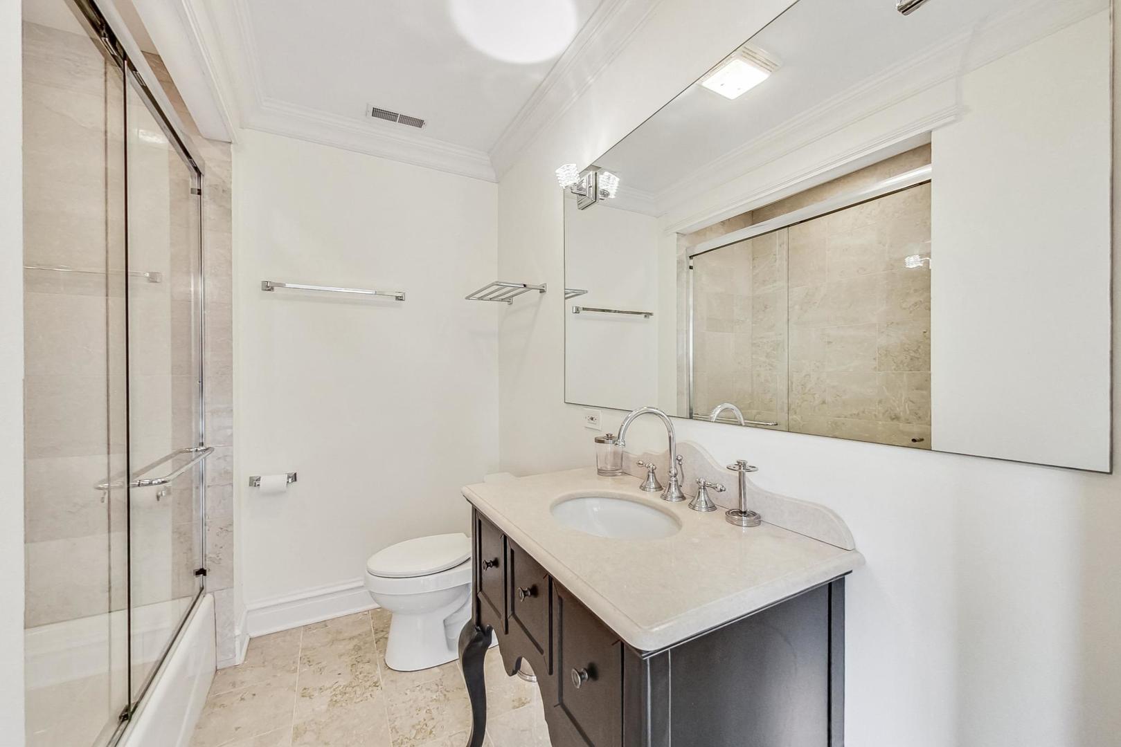50 MacArthur Loop Highland Park, IL 60035 - Photo 22 of 44 a bathroom with a sink toilet and shower