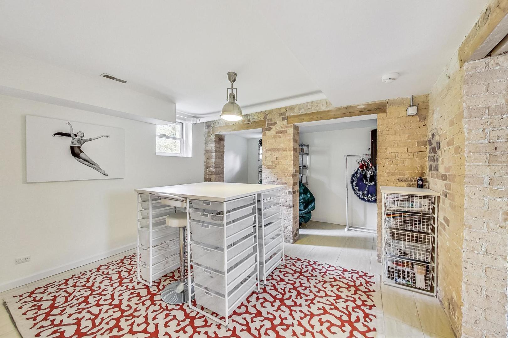50 MacArthur Loop Highland Park, IL 60035 - Photo 29 of 44 a bathroom with a sink a mirror and a shower