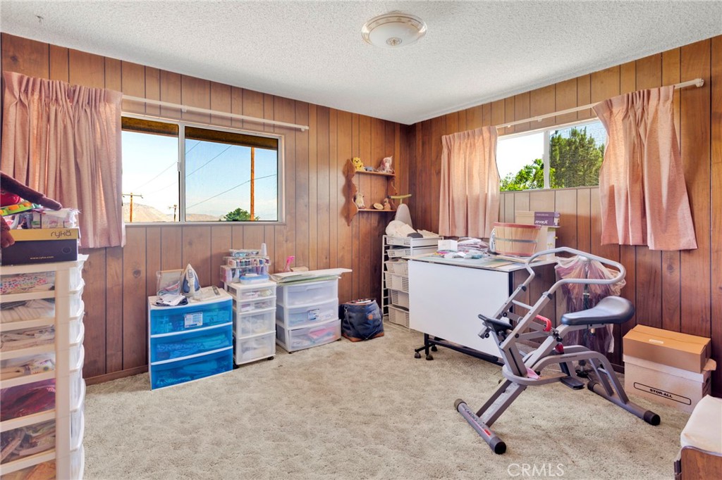5500 Oil Well Road Phelan, CA 92371 - Photo 32 of 65 a room with furniture a window and a chandelier