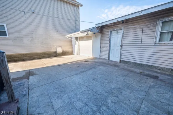 a view of a house with a yard and garage