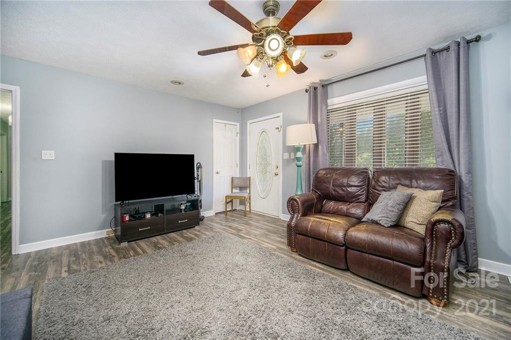 833 Long Branch Road Grover, NC 28073 - Photo 14 of 29 a living room with furniture and a flat screen tv