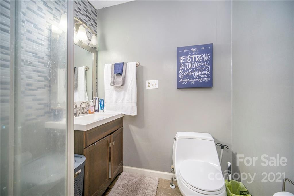 833 Long Branch Road Grover, NC 28073 - Photo 15 of 29 a bathroom with a toilet sink and mirror
