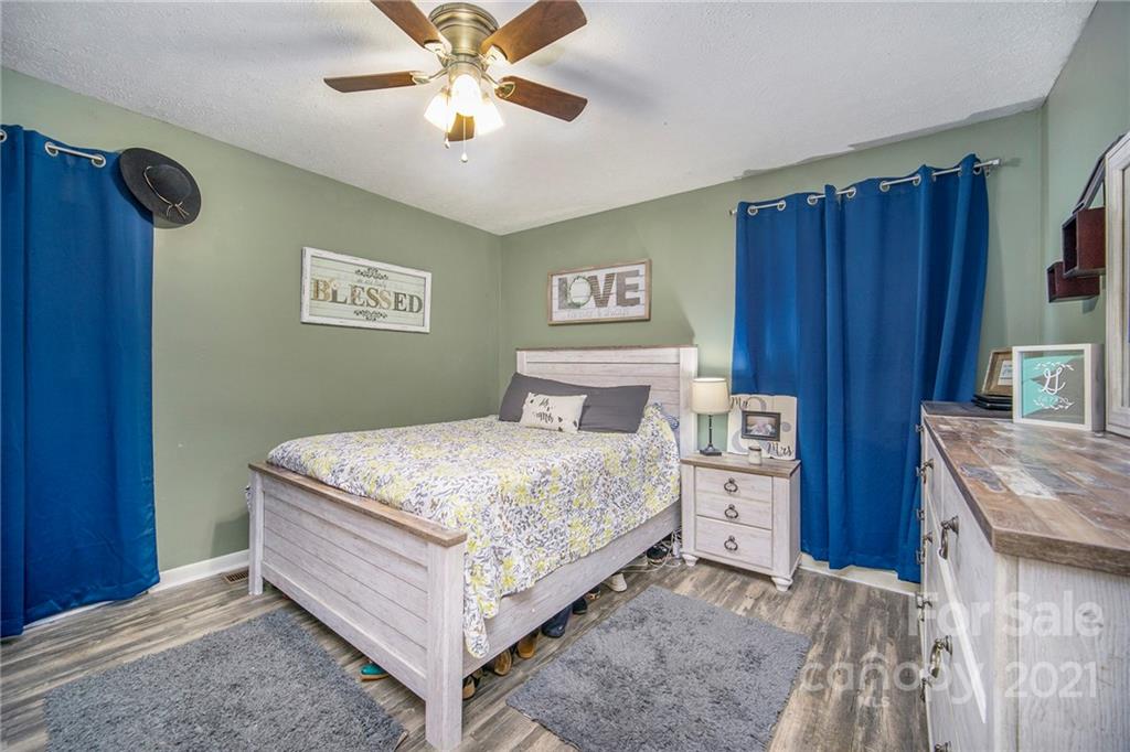 833 Long Branch Road Grover, NC 28073 - Photo 18 of 29 a bedroom with a bed and a chandelier
