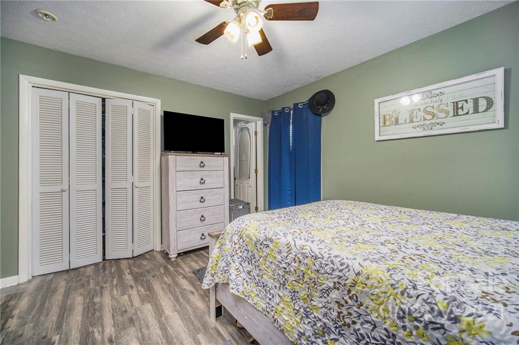 833 Long Branch Road Grover, NC 28073 - Photo 19 of 29 a bedroom with a bed and a flat screen tv