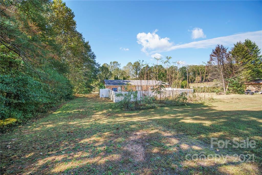 833 Long Branch Road Grover, NC 28073 - Photo 29 of 29 a view of a big yard with table and chairs and large trees