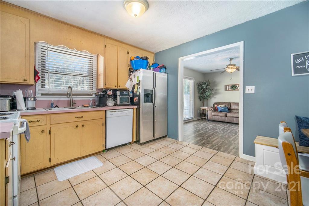 833 Long Branch Road Grover, NC 28073 - Photo 6 of 29 a large white kitchen with cabinets