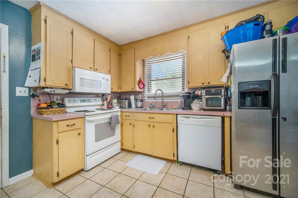 833 Long Branch Road Grover, NC 28073 - Photo 8 of 29 a kitchen with stainless steel appliances a refrigerator sink and cabinets