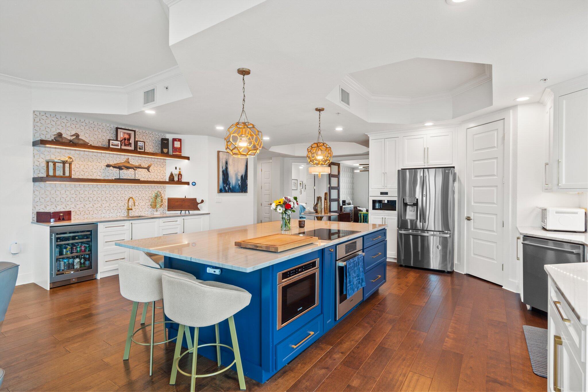 211 Durango Road, Unit 311 Destin, FL 32541 - Photo 17 of 71 a kitchen with stainless steel appliances a stove a sink a refrigerator and chairs
