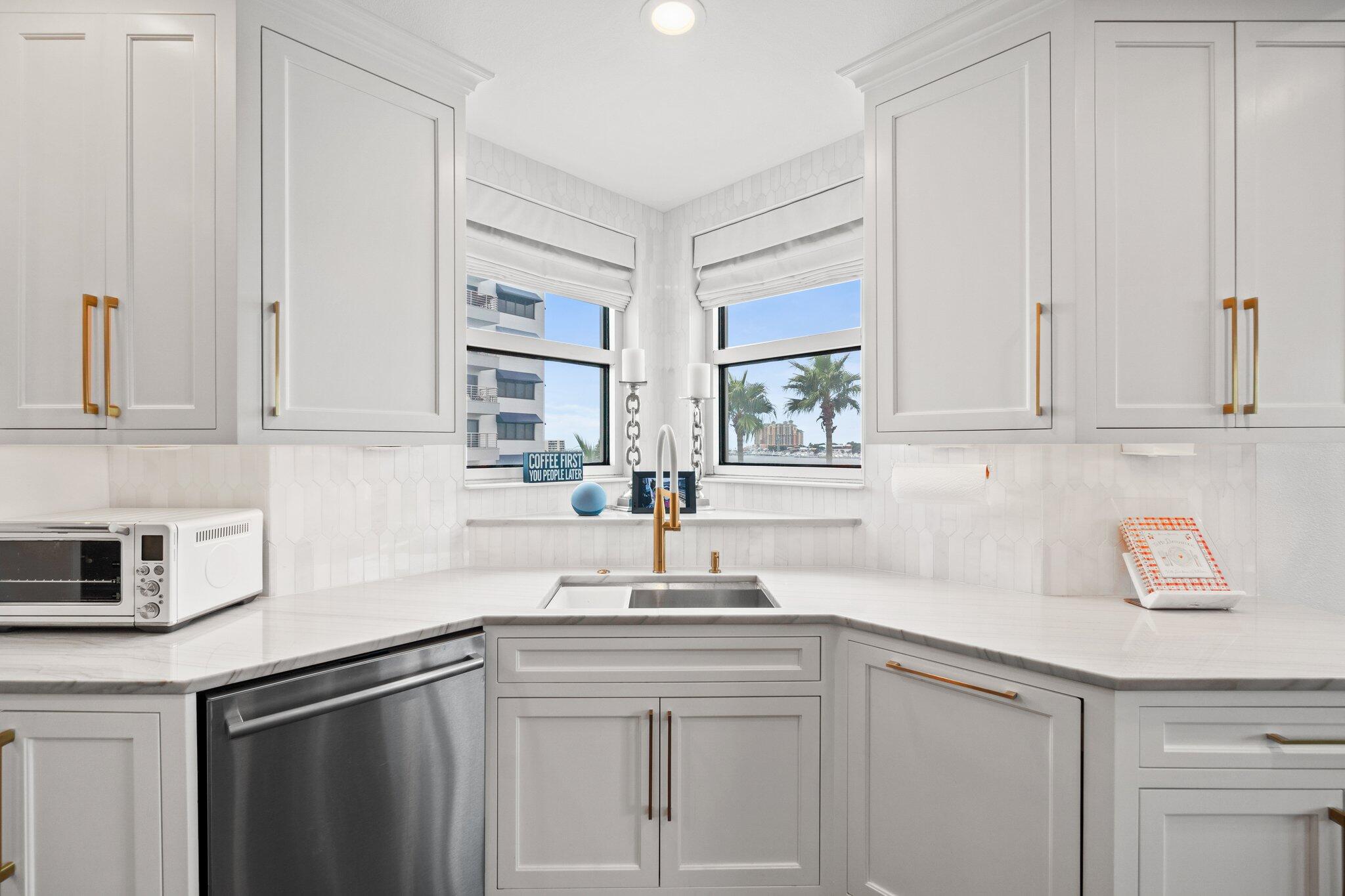 211 Durango Road, Unit 311 Destin, FL 32541 - Photo 18 of 71 a kitchen with stainless steel appliances white cabinets and a sink