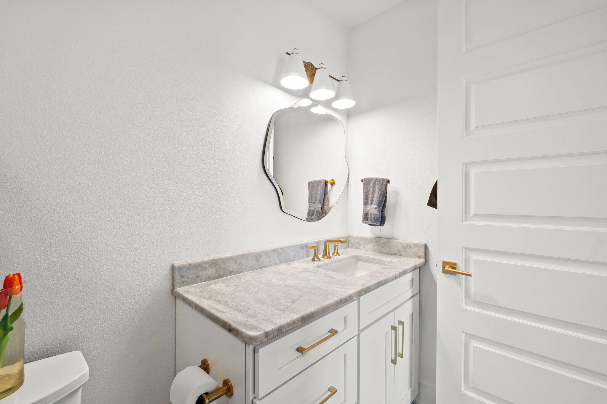 211 Durango Road, Unit 311 Destin, FL 32541 - Photo 32 of 71 a bathroom with a granite countertop sink a toilet and a mirror