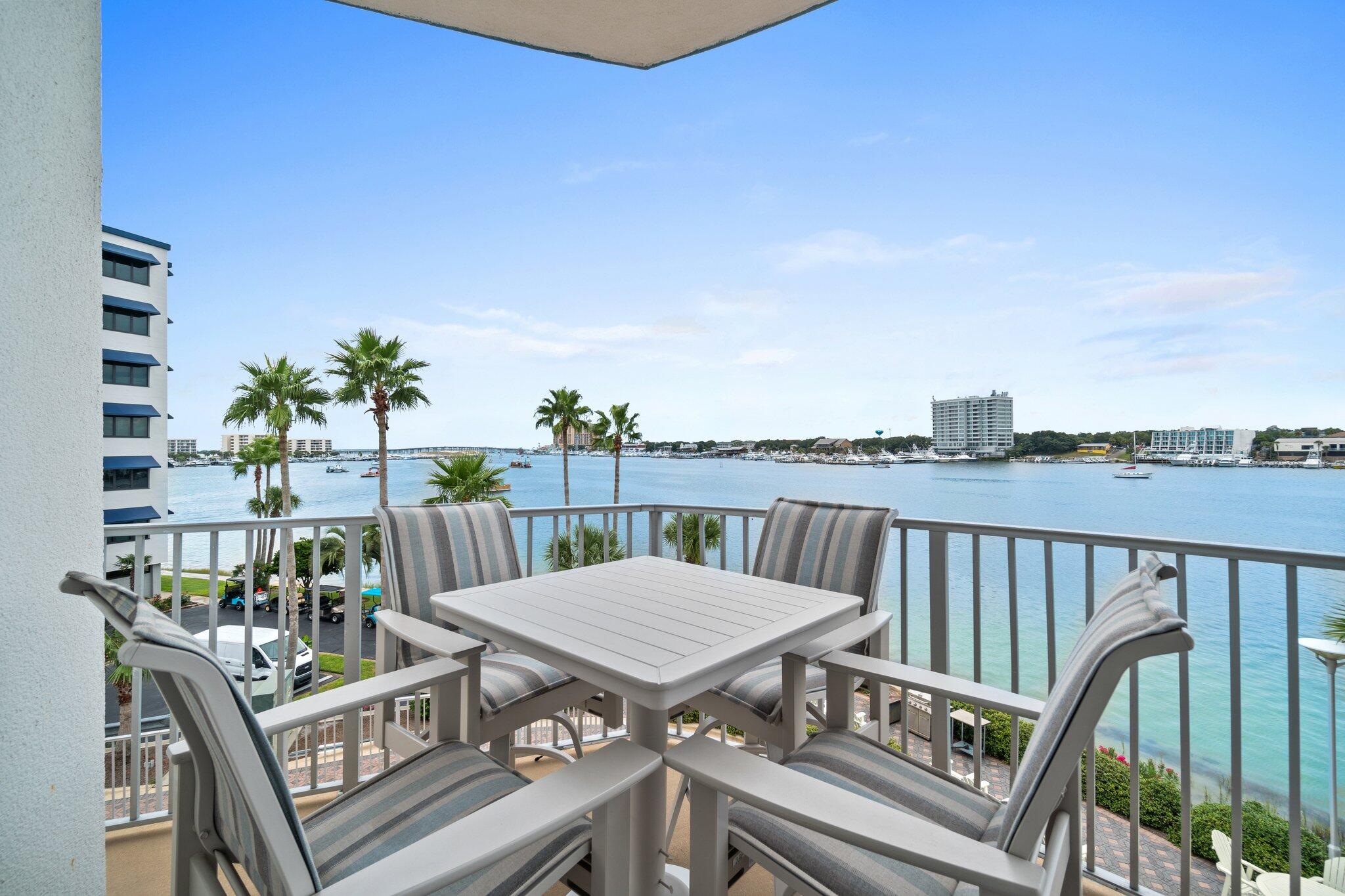 211 Durango Road, Unit 311 Destin, FL 32541 - Photo 48 of 71 a view of a balcony with wooden floor and outdoor seating