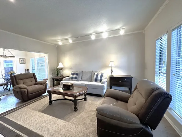 a living room with furniture and a lamp
