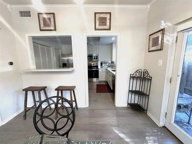 a kitchen with stainless steel appliances kitchen island granite countertop a stove a sink and a microwave