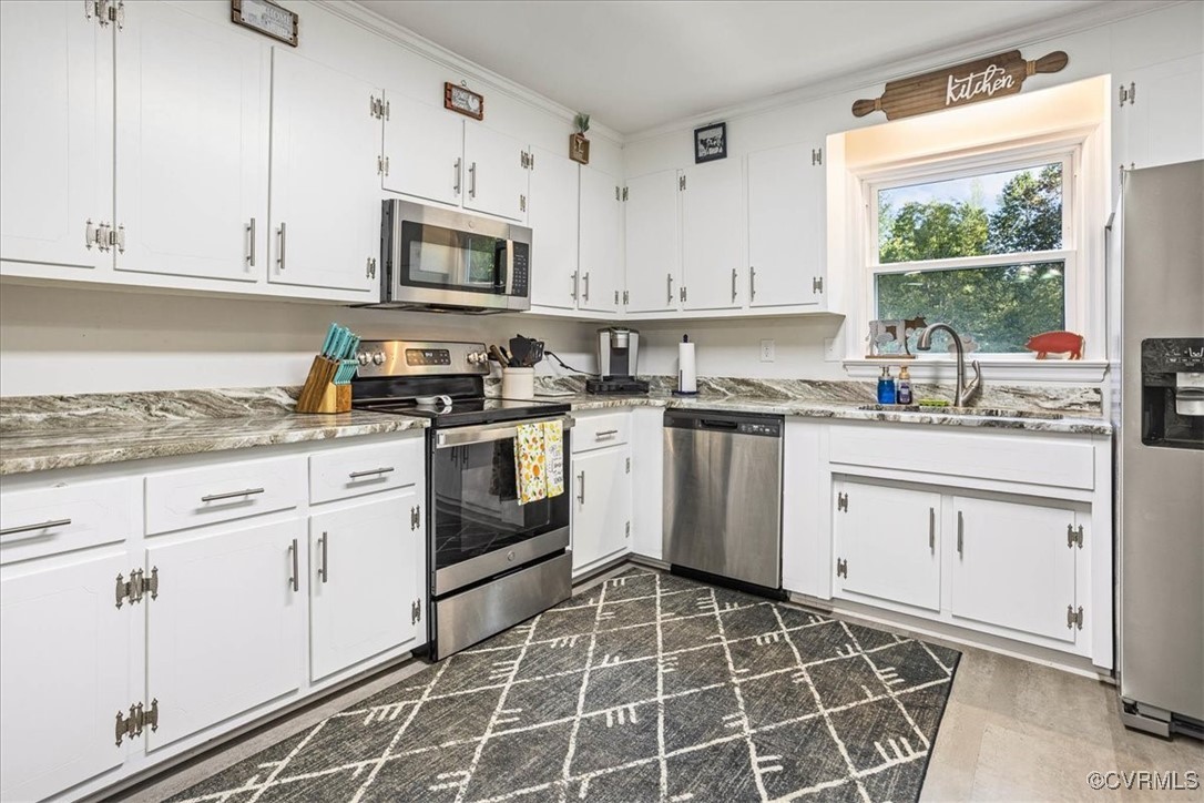 6314 Heritage Road Prince George, VA 23875 - Photo 11 of 26 Kitchen featuring dark tile patterned floors, appl