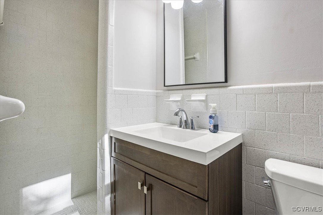6314 Heritage Road Prince George, VA 23875 - Photo 17 of 26 Bathroom with vanity, toilet, backsplash, and tile