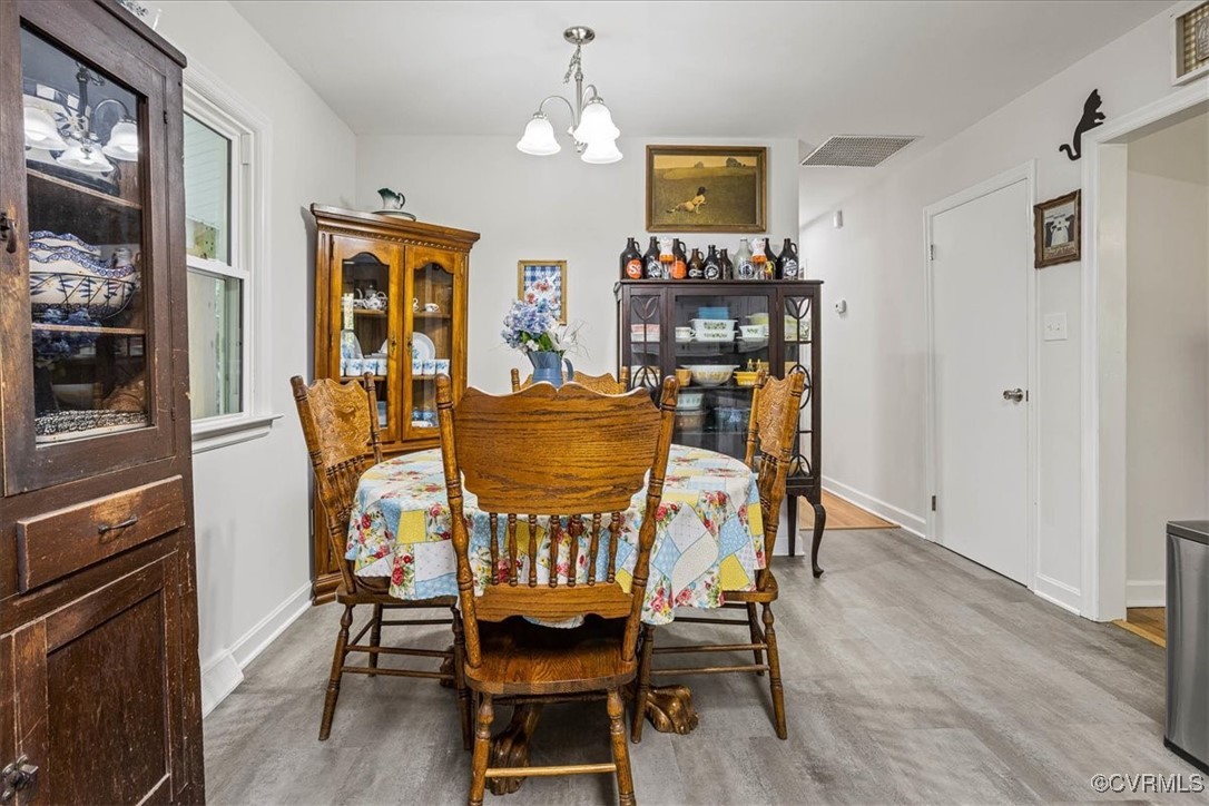 6314 Heritage Road Prince George, VA 23875 - Photo 10 of 26 Dining area featuring a chandelier and light hardw