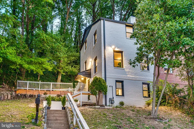 a view of house with a swimming pool and outdoor seating