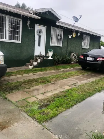 a front view of a house with a garden