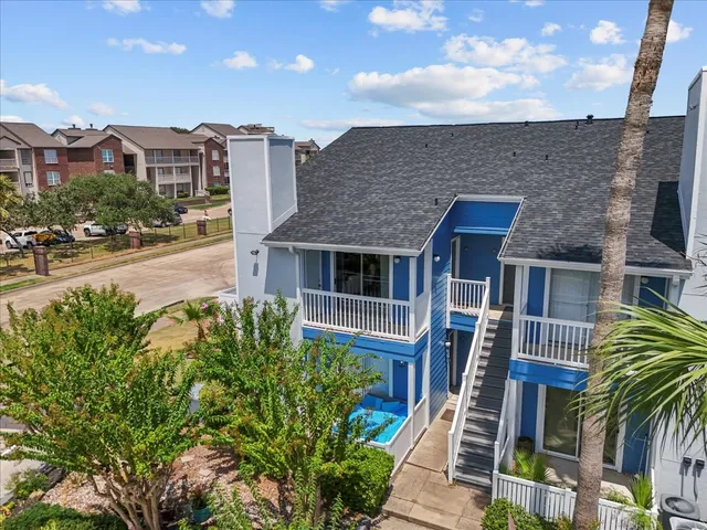 a front view of residential houses with yard and mountain view
