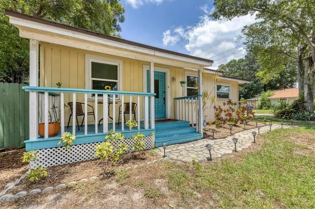 a view of a house with backyard porch and sitting area