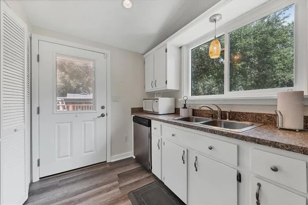 a kitchen with granite countertop a sink and a window