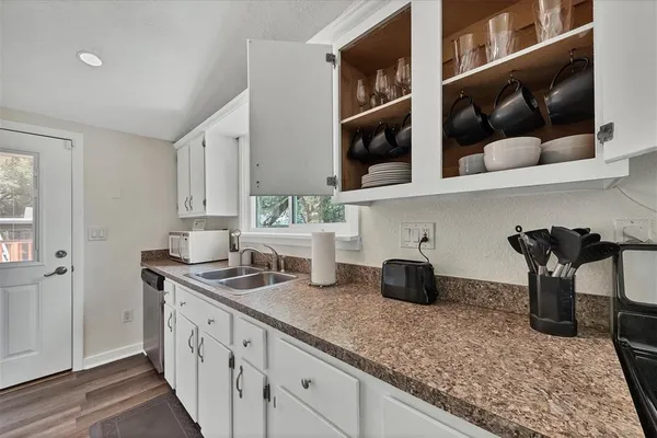 a kitchen with stainless steel appliances granite countertop a sink and cabinets