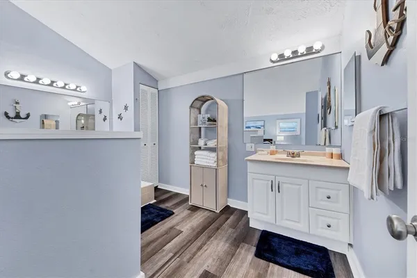 a spacious bathroom with a double vanity sink and a mirror