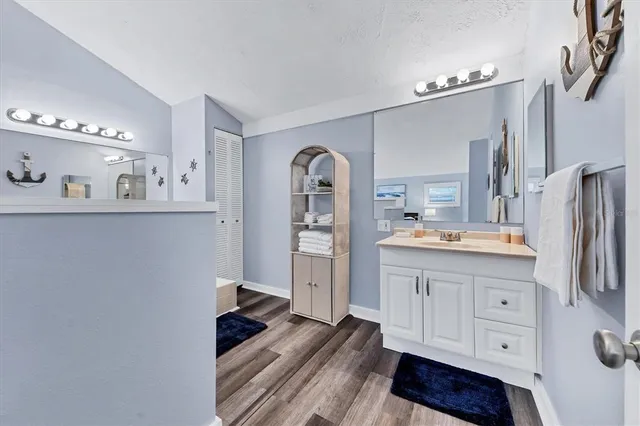 a spacious bathroom with a double vanity sink and a mirror