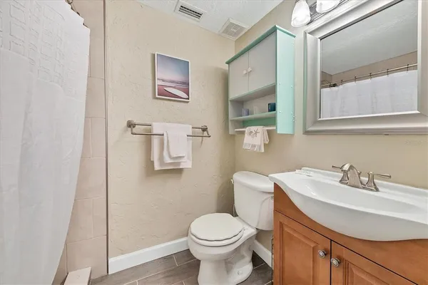 a bathroom with a sink toilet and mirror