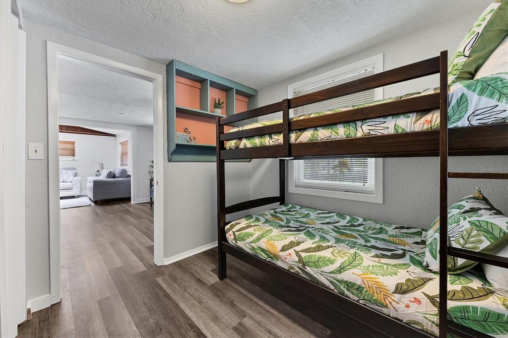 900 Beverly Avenue Northwest Largo, FL 33770 - Photo 23 of 32 a bedroom with a bed and wooden floor