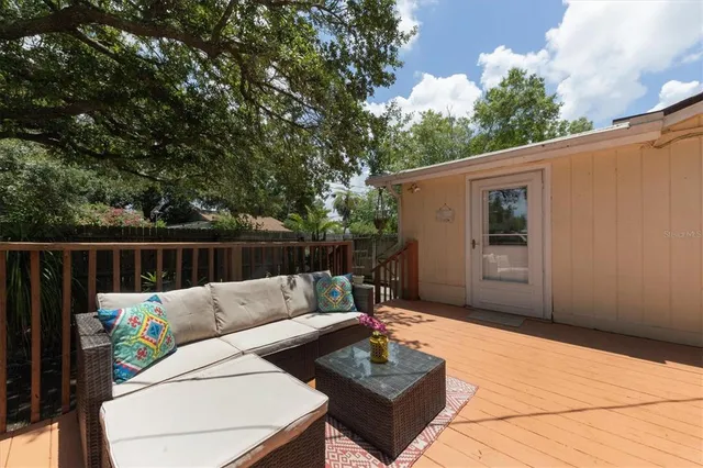 a backyard of a house with table and chairs