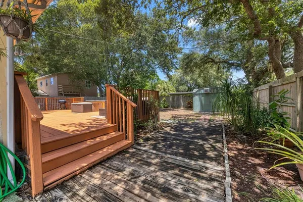 a view of a wooden bench next to a yard
