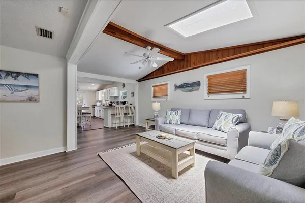 a living room with furniture and kitchen view
