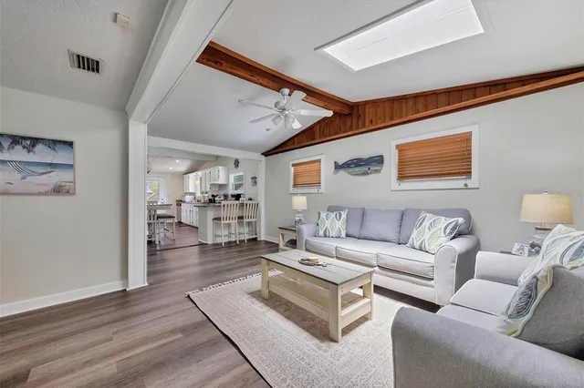 a living room with furniture and kitchen view
