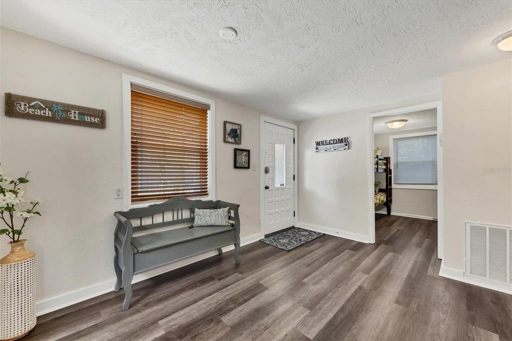 900 Beverly Avenue Northwest Largo, FL 33770 - Photo 6 of 32 an empty room with wooden floor and windows