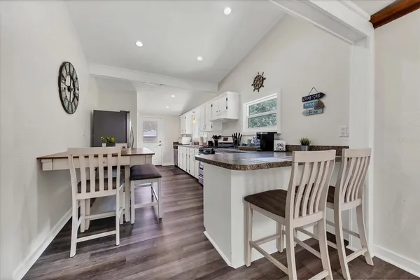 a view of a dining room with furniture and wooden floor