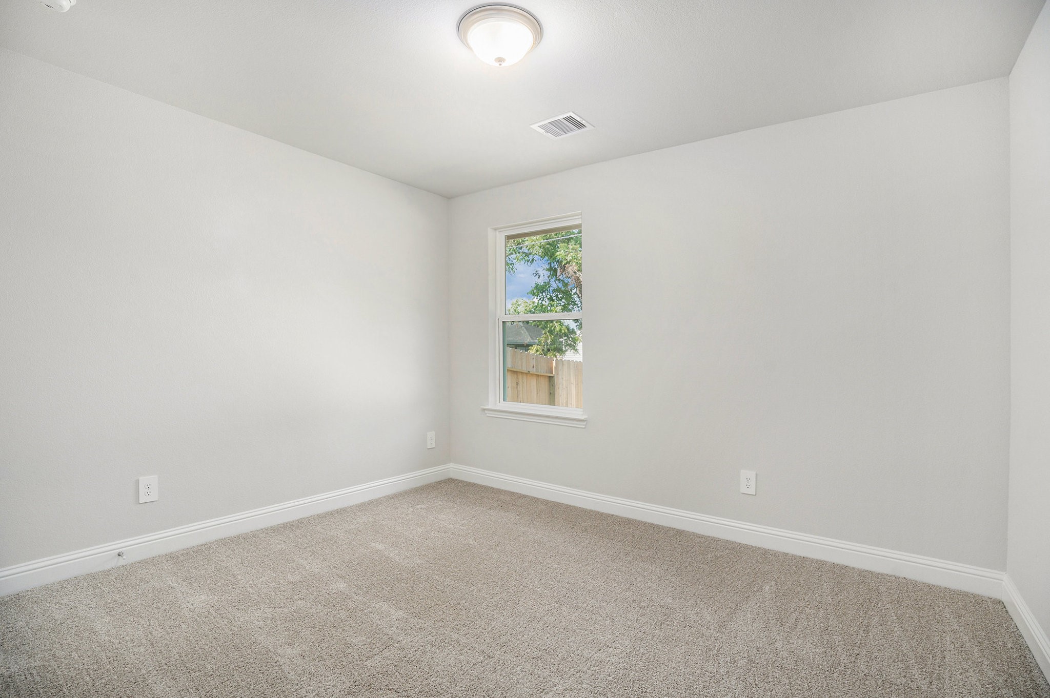 408 Bryan Street Angleton, TX 77515 - Photo 12 of 17 an empty room with a window