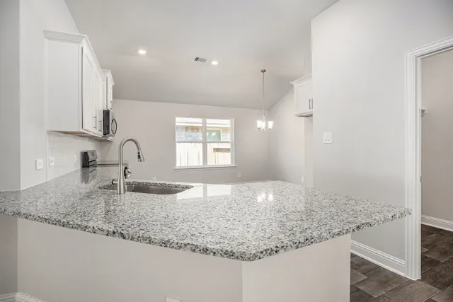 a kitchen with granite countertop a sink and a granite counter tops