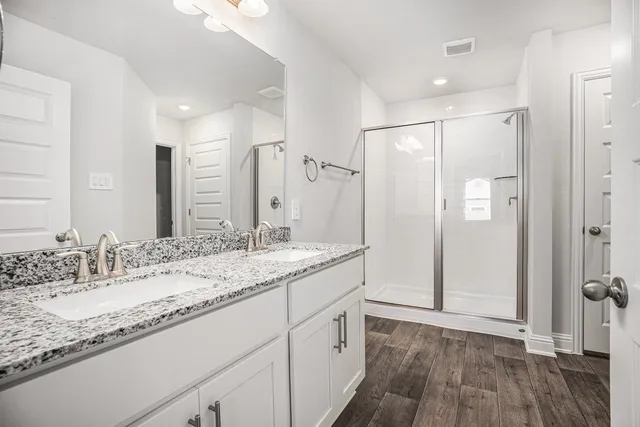 a bathroom with a granite countertop sink mirror and double