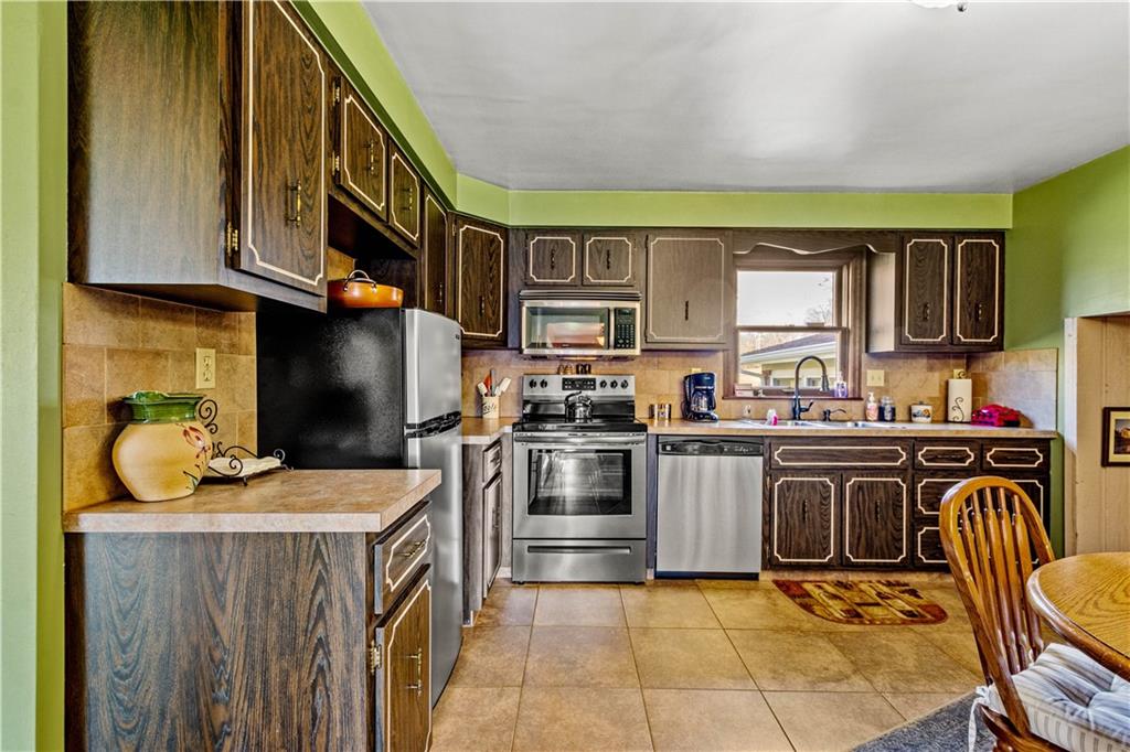 279 Hamtom Road Eighty Four, PA 15330 - Photo 8 of 25 a kitchen with stainless steel appliances granite countertop a stove top oven a sink a counter space and cabinets