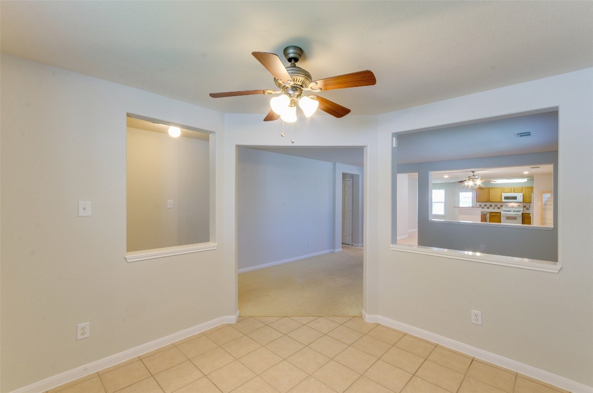 3302 Legends Landing Drive Spring, TX 77386 - Photo 12 of 48 a view of an empty room with window and chandelier fan