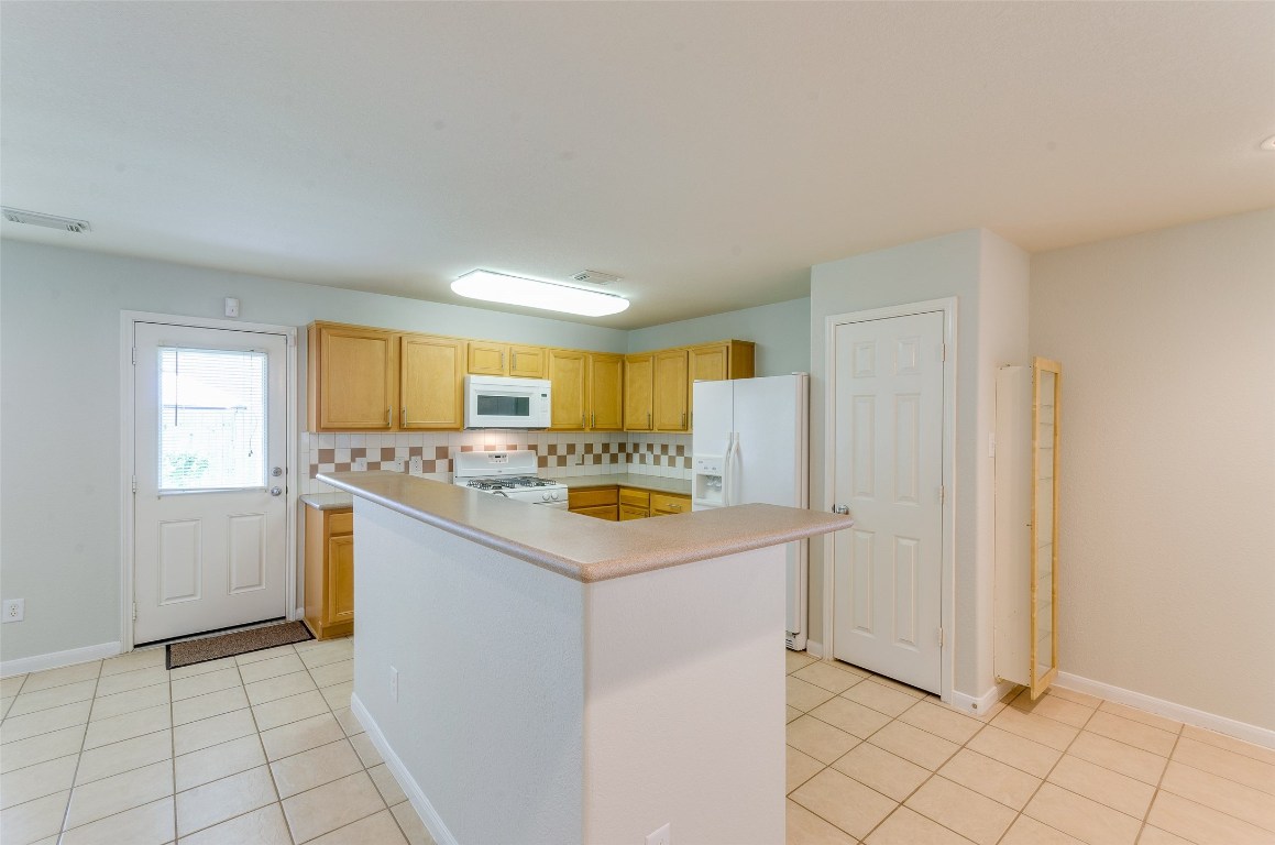 3302 Legends Landing Drive Spring, TX 77386 - Photo 20 of 48 a kitchen with a sink a stove cabinets and a window