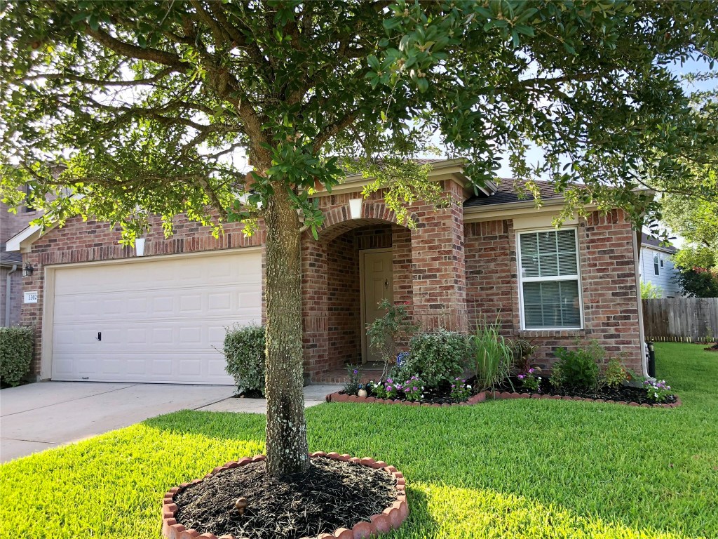 3302 Legends Landing Drive Spring, TX 77386 - Photo 2 of 48 a front view of a house with a garden and yard