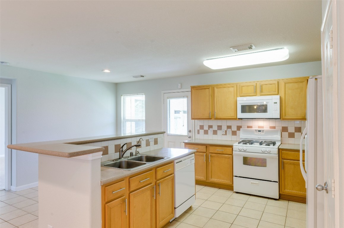 3302 Legends Landing Drive Spring, TX 77386 - Photo 21 of 48 a kitchen that has a sink and a stove