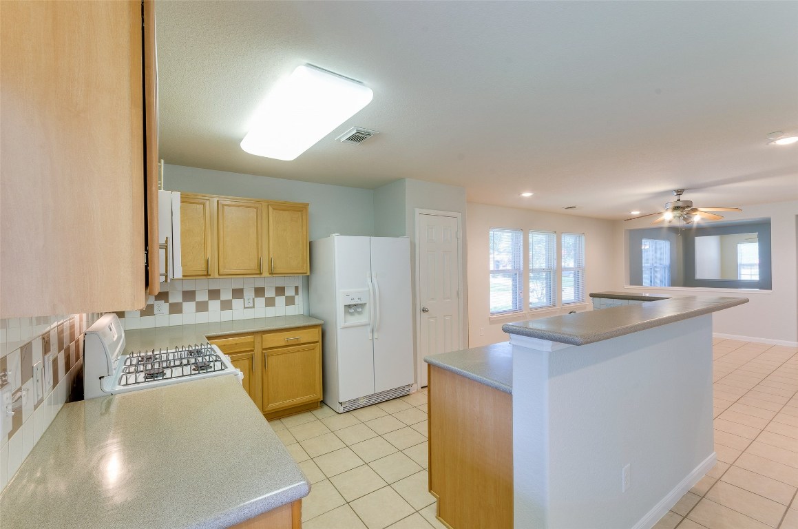 3302 Legends Landing Drive Spring, TX 77386 - Photo 22 of 48 a kitchen with stainless steel appliances granite countertop a sink and a stove