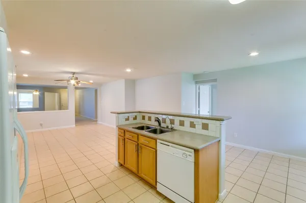 a kitchen that has a sink a stove and a microwave oven