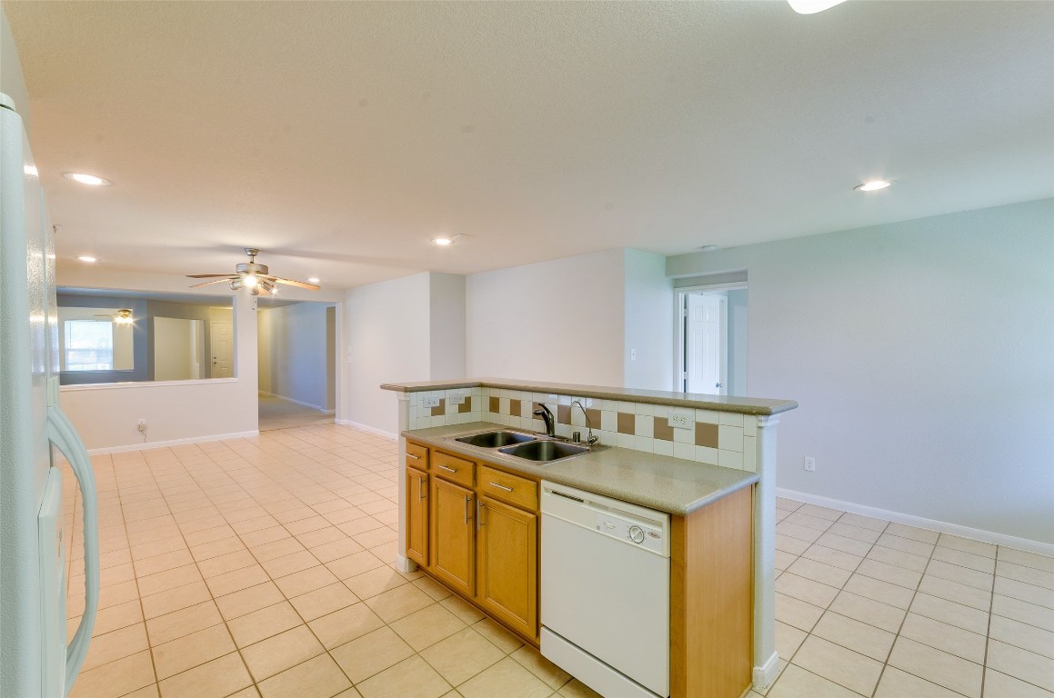 3302 Legends Landing Drive Spring, TX 77386 - Photo 23 of 48 a kitchen that has a sink a stove and a microwave oven