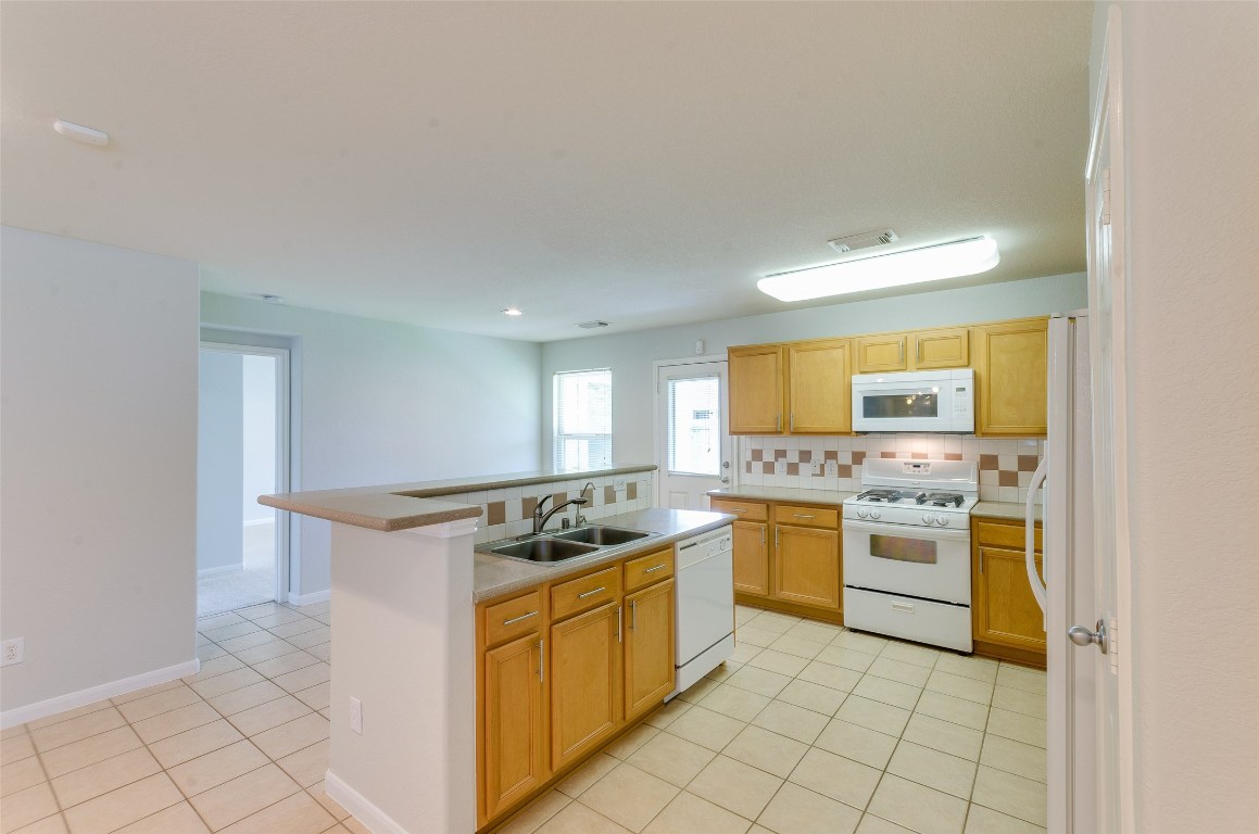 3302 Legends Landing Drive Spring, TX 77386 - Photo 24 of 48 a kitchen with a stove top oven and cabinets