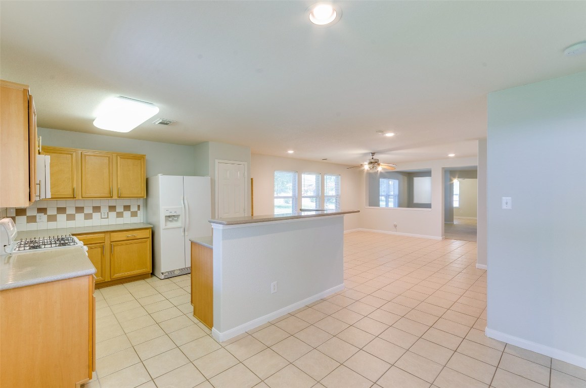3302 Legends Landing Drive Spring, TX 77386 - Photo 26 of 48 a large white kitchen with a stove a sink dishwasher and a refrigerator